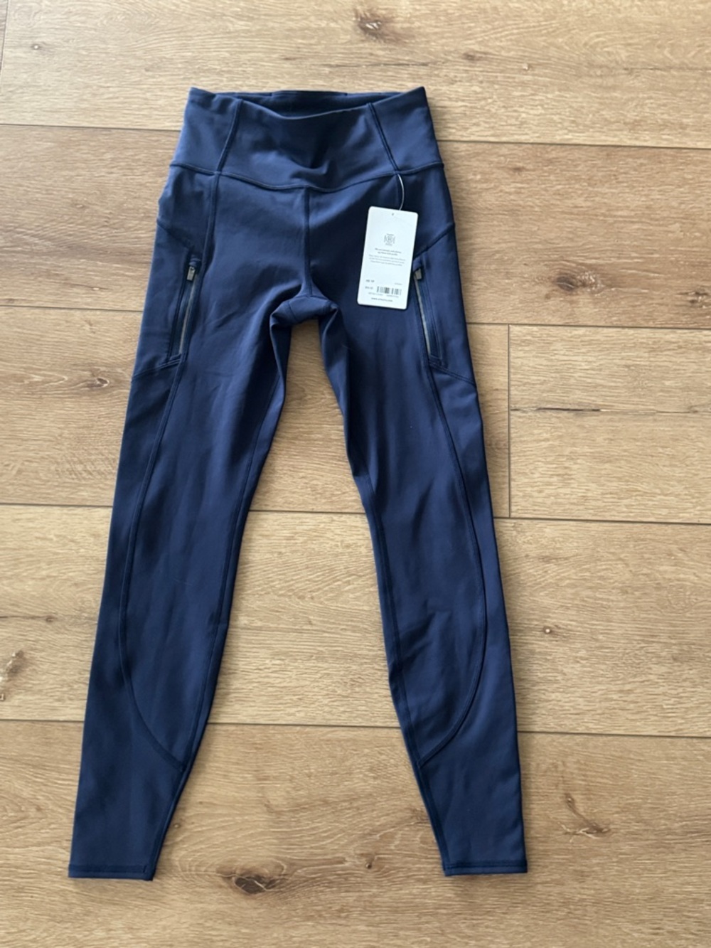 Brand new Athleta Rainier Navy Performance Leggings with Zipper Pockets